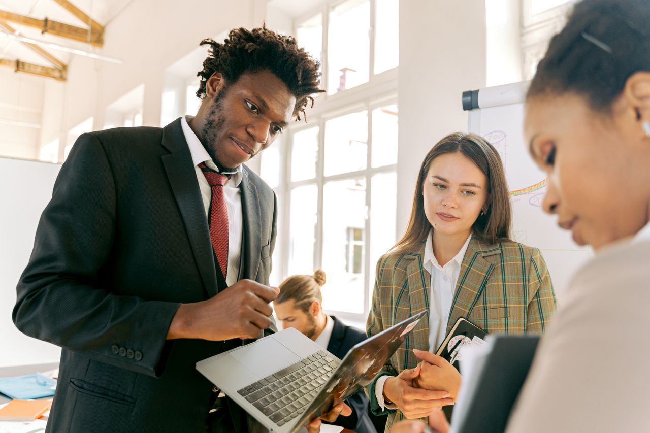 Team of diverse professionals collaborating in a modern office setting.